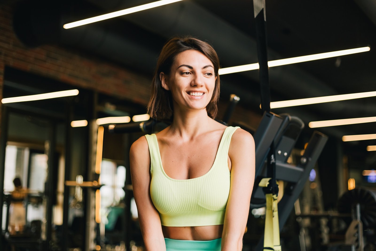 Fit caucasian beautiful woman in fitting sport wear at gym
